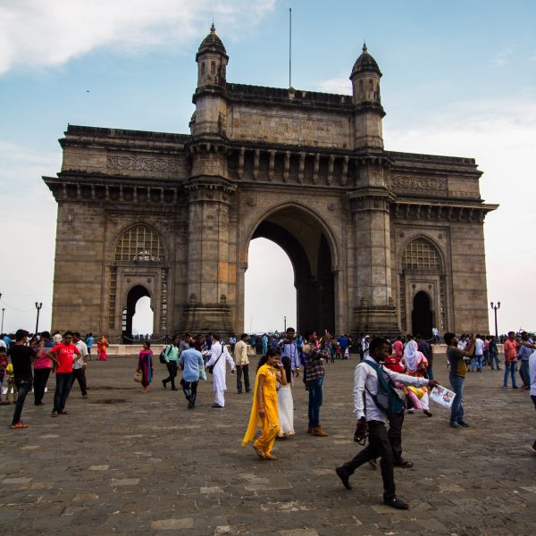 The Gateway of India during the day with tourists in the foreground