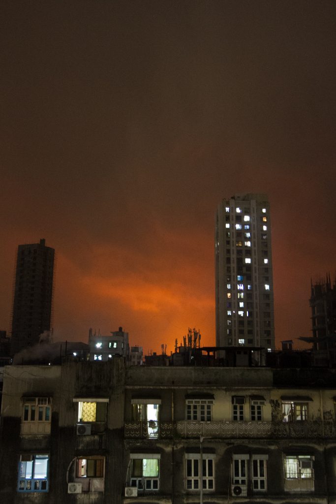 Oil fire burns in the distance in Mumbai