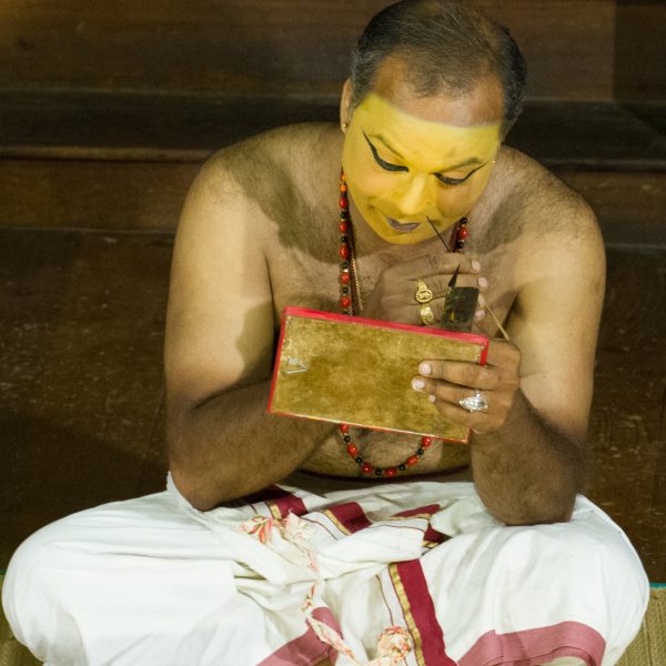 An actor applies the first layer of makeup before a Kathakali theatre show in Fort Kochi, Kerala, India