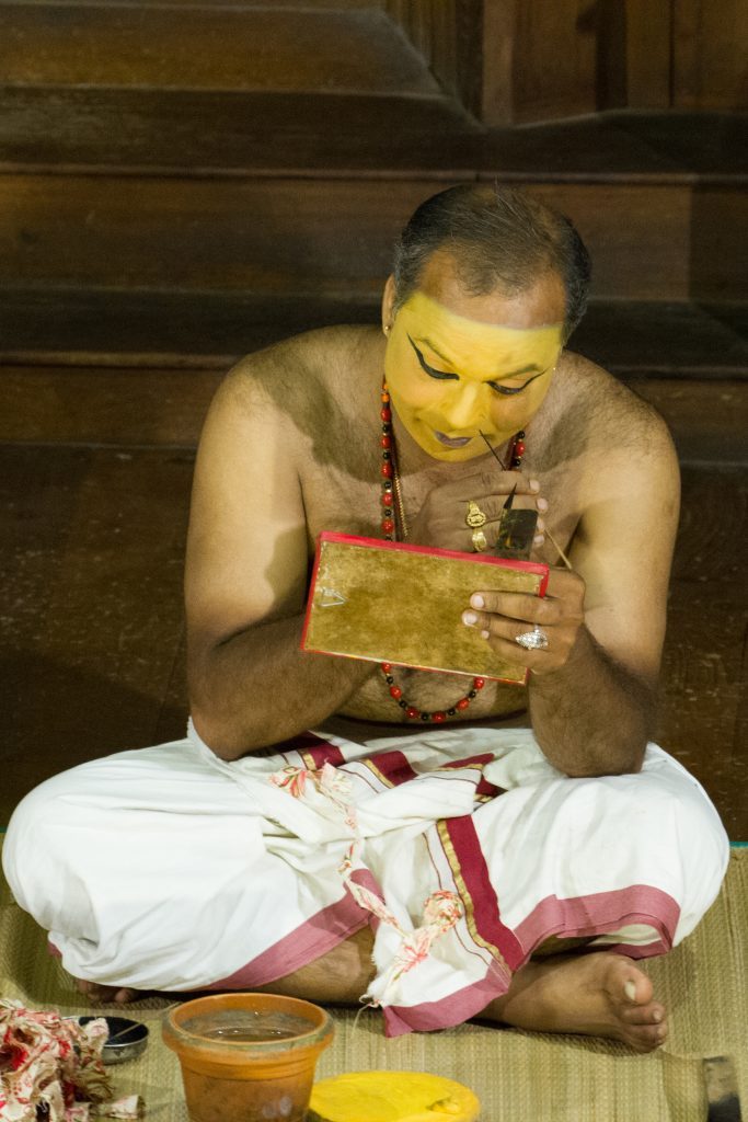 An actor applies the first layer of makeup before a Kathakali theatre show in Fort Kochi, Kerala, India
